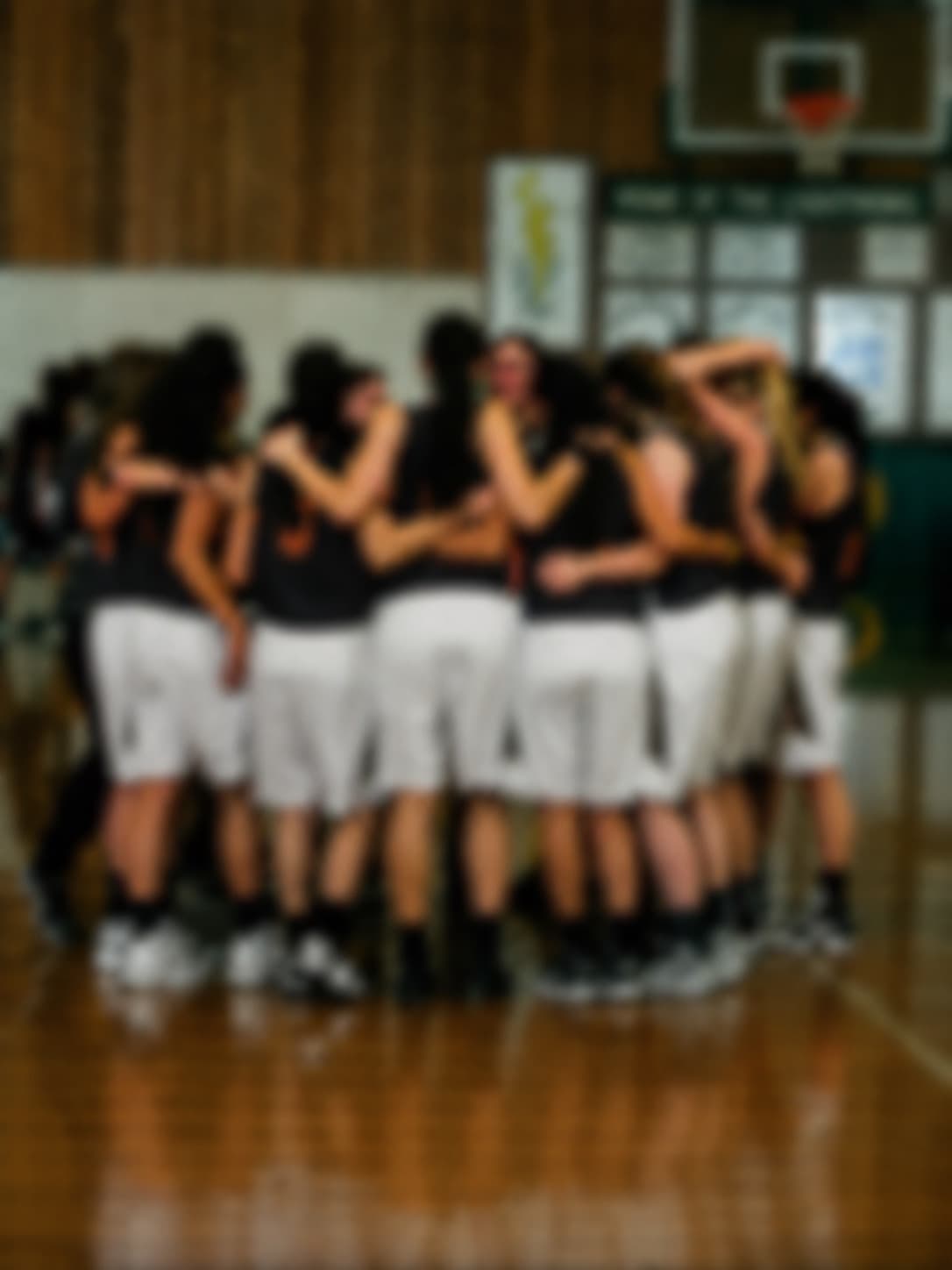 Coach huddling with the team on the court